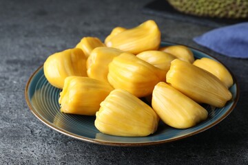 Fresh exotic jackfruit bulbs on grey table