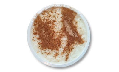 Top view of a bowl of rizogalo (rice pudding), a traditional Greek dessert that is made primarily from rice, milk, and sugar, simmered together until it reaches a creamy consistency. 