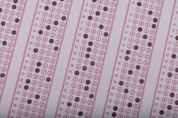 Exam, a hand taking an exam with a pen on an optical reader. Exam, an idea concept. Anxiety about the future, uncertainty. Multiple choice exam. Adults taking an exam.