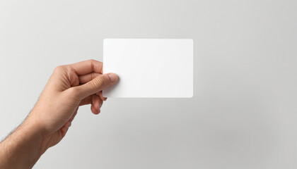 Hand holding a blank white card