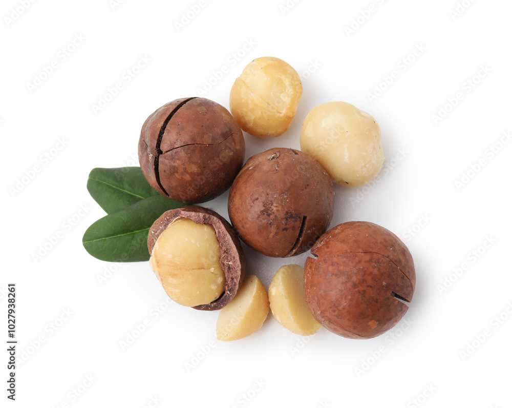 Wall mural Macadamia nuts with shells isolated on white, top view