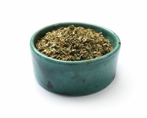 Dried oregano in bowl isolated on white