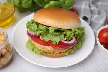 Delicious vegetarian burger with chickpea cutlet on white table, closeup