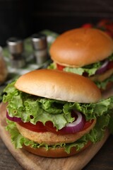 Delicious vegetarian burgers with chickpea cutlets on table, closeup