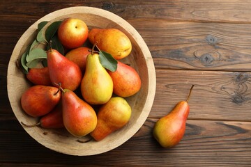Ripe juicy pears on wooden table, top view