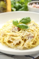 Delicious pasta Carbonara in bowl on table, closeup