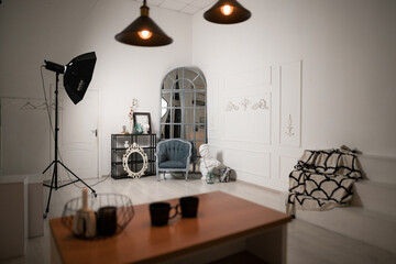 Cozy interior of a photographic studio featuring decor elements, soft lighting, and a vintage mirror in a creative workspace