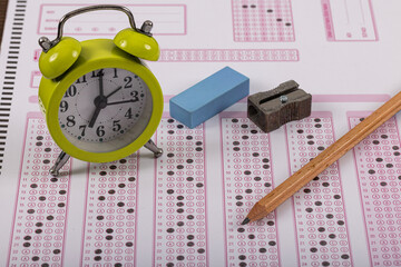 Exam, a hand taking an exam with a pen on an optical reader. Exam, an idea concept. Anxiety about the future, uncertainty. Multiple choice exam. Adults taking an exam.