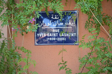 Street Sign for Rue Yves Saint Laurent Surrounded by Greenery in Marrakech
