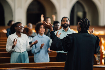 African american preacher leading congregation in prayer