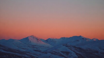 Fototapeta premium A stunning view of a mountain range at sunset, with a warm pink sky backdropping the scene and a lone airplane in the foreground, adds to its serene beauty