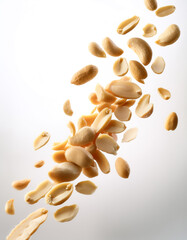 Flying peanuts slices, on a white background
