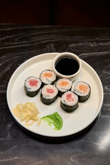 A Beautiful Plate Filled with Delicious Sushi Rolls Accompanied by Soy Sauce for Dipping