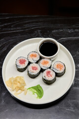 A Beautiful Plate Filled with Delicious Sushi Rolls Accompanied by Soy Sauce for Dipping
