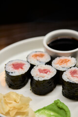 A Beautiful Plate Filled with Delicious Sushi Rolls Accompanied by Soy Sauce for Dipping