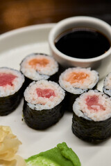 A Beautiful Plate Filled with Delicious Sushi Rolls Accompanied by Soy Sauce for Dipping
