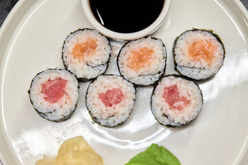 A Beautiful Plate Filled with Delicious Sushi Rolls Accompanied by Soy Sauce for Dipping