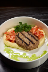 Savor a Grilled Steak served with Tomato Salsa and Green Sauce, beautifully presented