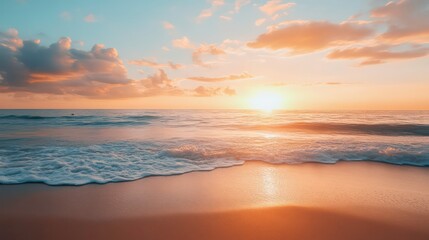 A vibrant sunset over a calm ocean with gentle waves crashing on the sandy shore. The sky is filled with clouds reflecting the golden light of the setting sun.