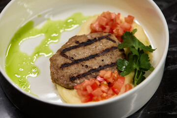 Savor a Grilled Steak served with Tomato Salsa and Green Sauce, beautifully presented