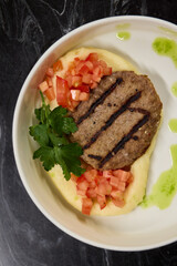 Savor a Grilled Steak served with Tomato Salsa and Green Sauce, beautifully presented