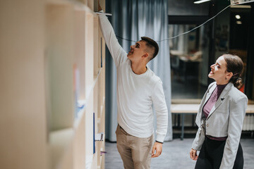 Obraz premium Two high school students are exploring books on a library shelf, showcasing curiosity and learning in an educational environment. They appear engaged and focused, embodying school life and academic