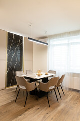Modern apartment interior featuring a stylish dining area with sleek design elements and natural light in an inviting space