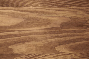 Applying walnut wood stain. Texture of wooden surface as background, top view