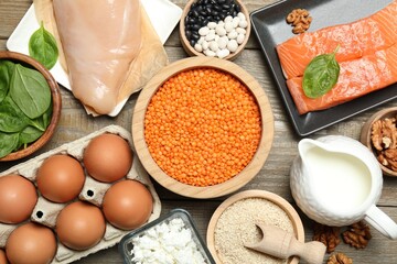 Different products rich in estrogen on wooden table, flat lay