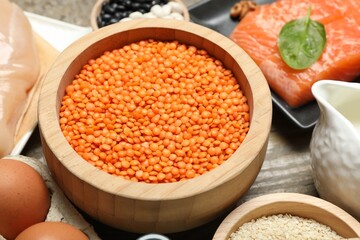 Different products rich in estrogen on wooden table, closeup