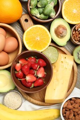 Different products rich in dopamine on wooden table, flat lay