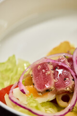 A Fresh and Colorful Salad with a Variety of Fresh Vegetables and Sliced Onions Included