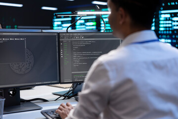 Programmer in server farm checking recovery plan, monitoring data center energy consumption. Employee in server room making sure sensors are functioning optimally, doing routine disk checks using PC