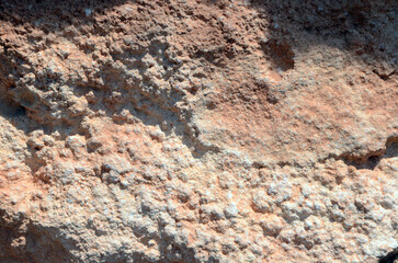 Background. Uneven stone surface with chiaroscuro and pinkish tint. Mallorca Island. Spain