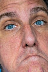 Funny, angry and weird face expression of a close up man.