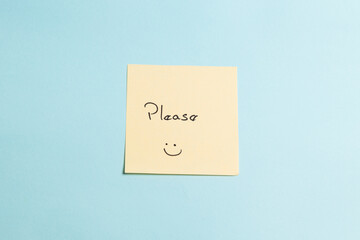 A yellow sticky note with a smiley face on it