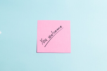 A pink sticky note with the words 