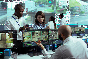 Diverse staff sharing insight on cargo logistics and monitoring activity through traffic, following...