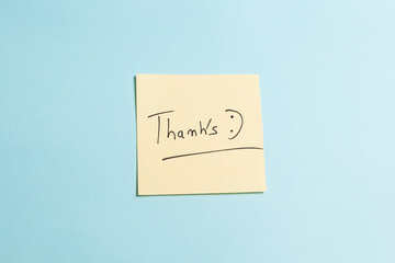 A yellow sticky note with the word 