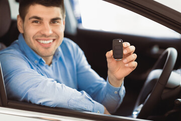Joyful Businessman Showing Car Key Smiling To Camera Sitting In Driver's Seat In New Automobile...