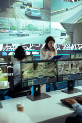 Team leader overseeing diverse operators in delivery call center office, employees using global...