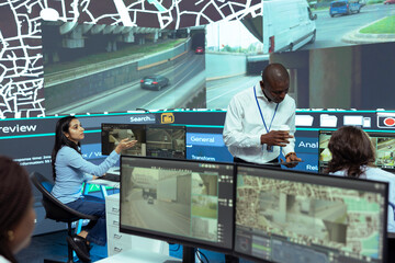 African american team leader supervising shipment activity in monitoring room, agency ensuring...