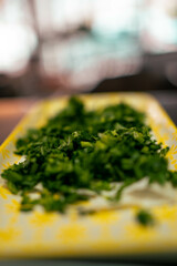 A bunch of freshly chopped parsley. Great for cooking tutorials, food blogs, or advertisements focusing on fresh, aromatic ingredients.