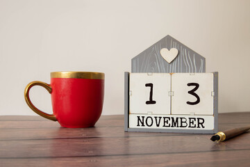 13 November on wooden grey cubes. Calendar cube date 13 November.