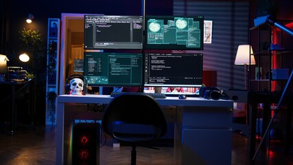 Lines of code running on computer monitors in empty room used by cybercriminal stealing sensitive...