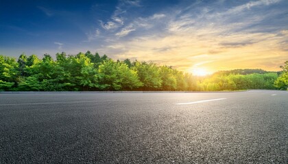 Fototapeta premium asphalt road square and green forest natural landscape at sunset