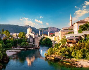 Fototapeta premium fantastic skyline of mostar with the mostar bridge houses and minarets during sunny day