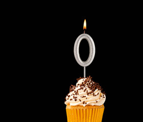 Birthday cupcake on black background - Number 0 shaped candles.