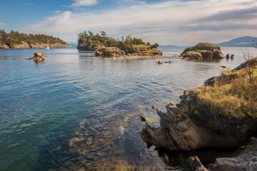 Aerial View of Kayakers in Ewing Cove, Sucia Island, Washington. Emerald waters and sandstone formations make Sucia Island a must go destination for kayakers worldwide. Located in the Salish Sea area.