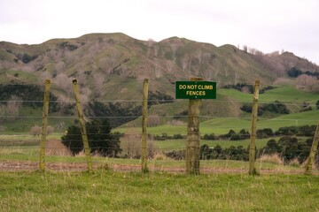 Do Not Climb Fences’ Sign on Rural Fence - Safety Warning in Countryside